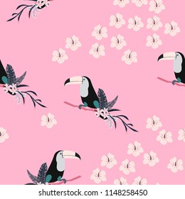 Tropical seamless pattern with toucan, flowers and leaves. Beautiful background with tropical leaves and flowers. Birds of the jungle. For covers, paper, wallpaper and fabric.