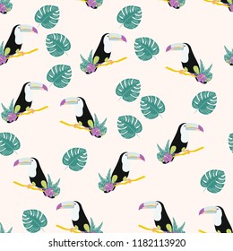Tropical seamless pattern with toucan, flowers and leaves. A tropical forest with birds. Stylish tropical background with toucan.