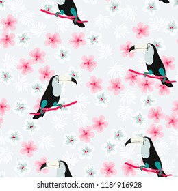 Tropical seamless pattern with toucan, flowers and leaves. A tropical forest with birds. Stylish tropical background with toucan.