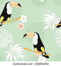 Tropical seamless pattern with toucan, flowers and leaves. Beautiful background with tropical leaves and flowers. Birds of the jungle. For covers, paper, wallpaper and fabric.