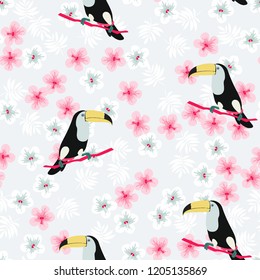 Tropical seamless pattern with toucan, flowers and leaves. A tropical forest with birds. Stylish tropical background with toucan.