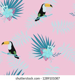 Tropical seamless pattern with toucan, flowers and leaves. Beautiful background with tropical leaves and flowers. Birds of the jungle. For covers, paper, wallpaper and fabric.