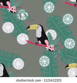 Tropical seamless pattern with toucan, tropical leaves and citrus. Lemon and lime. Summer background with tropical birds.