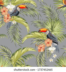 Tropical seamless vector pattern with flowers, palm leaves and birds. Exotic Toucan snd hibiscus flowera. Jungle illustration .