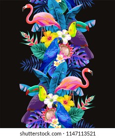 Tropical seamless vertical border with palm leaves, exotic flowers, parrots and flamingos on a black background. Vector illustration.