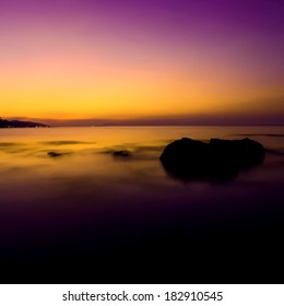 Tropical sunset on the beach. Vector illustration