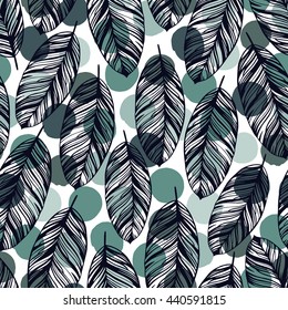 Tropical trendy seamless pattern with exotic leaves on a polka dot background