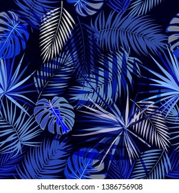 Tropical vector seamless pattern of blue leaves on dark background. Botany design, jungle leaves of palm tree and flowers.