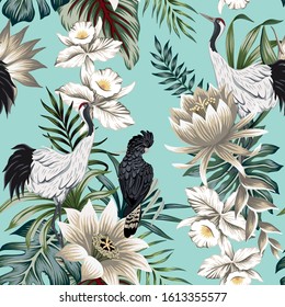 Tropical vintage crane bird, parrot, lotus flower, palm leaves, white orchid floral seamless pattern blue background. Exotic jungle wallpaper.