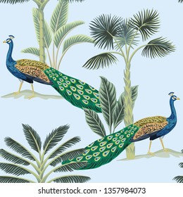 Tropical vintage peacock bird, palm tree and plant floral seamless pattern blue background. Exotic jungle wallpaper.