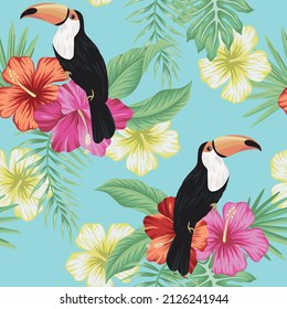 Tropical vintage toucan bird, red magenta yellow hibiscus flower, palm leaves floral seamless pattern blue background. Exotic jungle wallpaper.