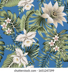 Tropical vintage white orchid, lotus flower, palm leaves, floral seamless pattern blue background. Exotic jungle wallpaper.