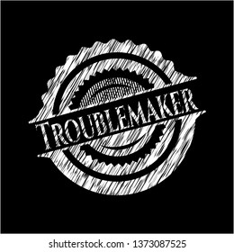 Troublemaker chalk emblem written on a blackboard