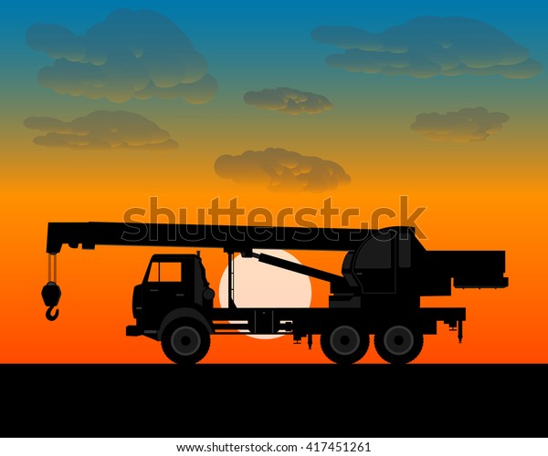 truck crane for lifting building materials in the\
evening at sundown