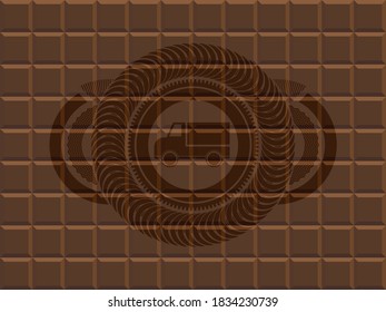 truck icon inside chocolate bar realistic badge. Brown chic background. Vector illustration. 
