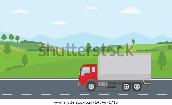 Truck moving on asphalt road along the green fields in\
rural landscape. Transport services concept. Flat style vector\
illustration. 