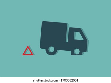 Truck with red warning triangle and punctured front wheel