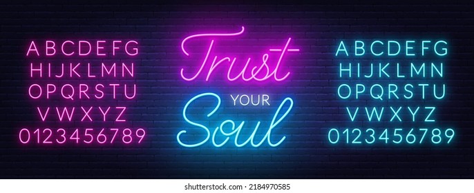 Trust your soul neon quote on a brick wall.