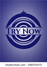 Try Now emblem with jean texture. Vector Illustration. Detailed.