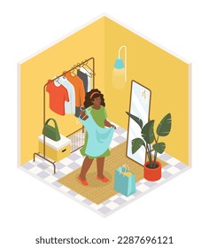 Trying on clothes in the dressing room - vector colorful isometric illustration. T-shirts and dresses hang on hanger, girl stands in front of a mirror with fashionable sundress. Fashion and style idea
