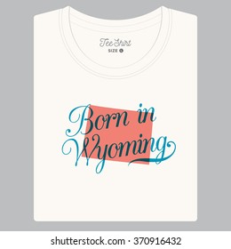 T-shirt with logo text "Born in Wyoming " and the State map. Editable vector design. 