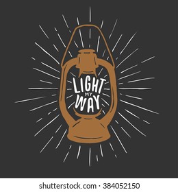 T-shirt print with oil lamp and quote. Light my way. Trendy hand drawn design element. Vector vintage illustration.