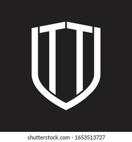 Monograma de logotipo TT con diseño de escudo de emblemas aislado en fondo negro