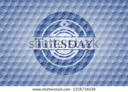 Tuesday blue badge with geometric pattern.