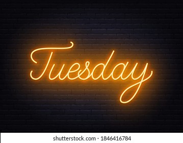 Tuesday neon sign on brick wall background.