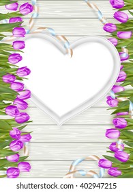 Tulips with blank white picture heart shape frame on a wooden background. Romantic picture. EPS 10 vector file included