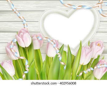 Tulips with blank white picture heart shape frame on a wooden background. Romantic picture. EPS 10 vector file included
