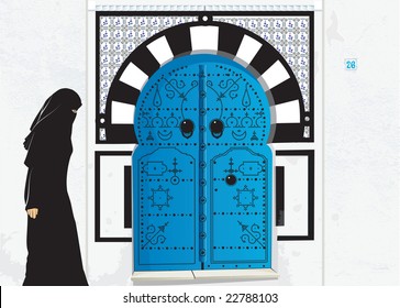 Tunisian woman in front of Tunisian door, in Sidi Bou Said town ,Tunis.