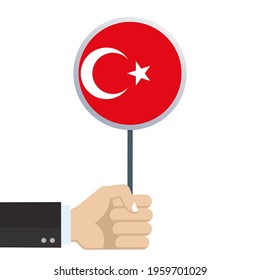Turkey circular flag. Hand holding round Turkish flag. National symbol with moon and star. Vector illustration. 