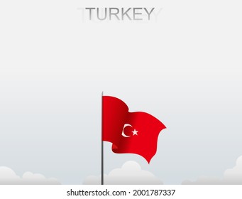 Turkey flag flying on a pole standing tall under the white sky