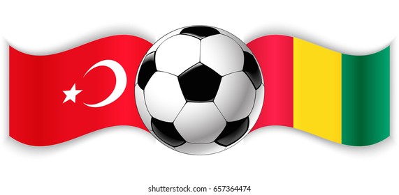 Turkish and Guinean wavy flags with football ball. Turkey combined with Guinea isolated on white. Football match or international sport competition concept.