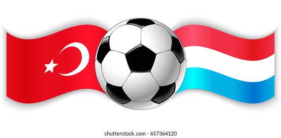 Turkish and Luxembourgish wavy flags with football ball. Turkey combined with Luxembourg isolated on white. Football match or international sport competition concept.