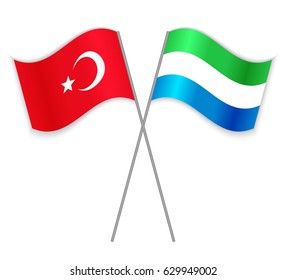 Turkish and Sierra Leonean crossed flags. Turkey combined with Sierra Leone isolated on white. Language learning, international business or travel concept.