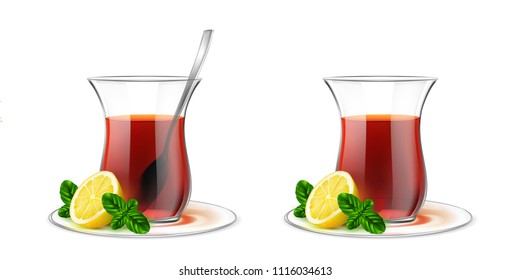 Turkish transparent tea cup with black tea, silver spoon, mint and lemon. Armudu glass