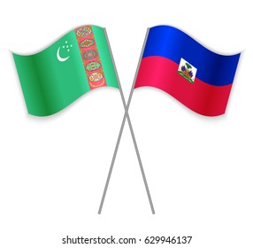 Turkmen and Haitian crossed flags. Turkmenistan combined with Haiti isolated on white. Language learning, international business or travel concept.