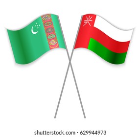 Turkmen and Omani crossed flags. Turkmenistan combined with Oman isolated on white. Language learning, international business or travel concept.