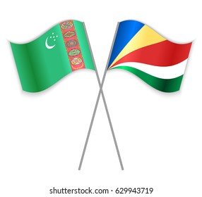 Turkmen and Seychellois crossed flags. Turkmenistan combined with Seychelles isolated on white. Language learning, international business or travel concept.