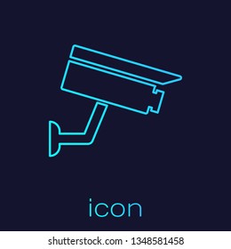 Turquoise Security camera line icon isolated on blue background. Vector Illustration