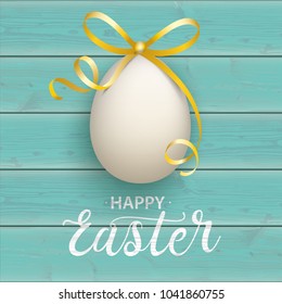 Turquoise wooden background with easter egg and text happy easter.  Eps 10 vector file.