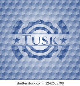 Tusk blue emblem with geometric background.