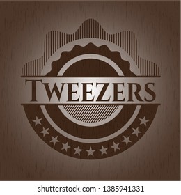 Tweezers retro wooden emblem. Vector Illustration.