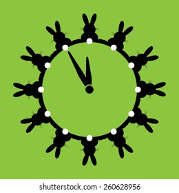 twelve black bunnies with white tails as wall clocks on a green background