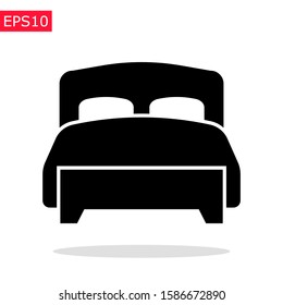 Twin bed icon with soft blanket and pillows. Isolated vector sign. Bedroom spictogram.