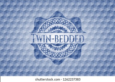 Twin-bedded blue emblem with geometric pattern.