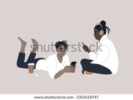 Two adolescents engrossed in their electronic devices, their interaction transitioning from the physical world to the virtual realm of online social media