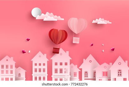 Two air balloons flew over a house in town. symbol of the love of a hot air balloon. There is a pink background. paper art design